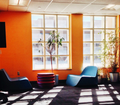 Sunlight streams into a small study area in Zimmerman Library where chairs await occupants